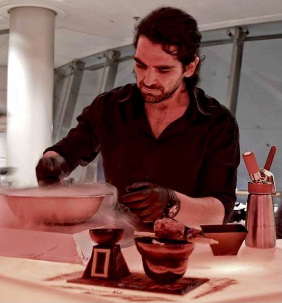 Plating a smoking serve on the event pass under warm light
