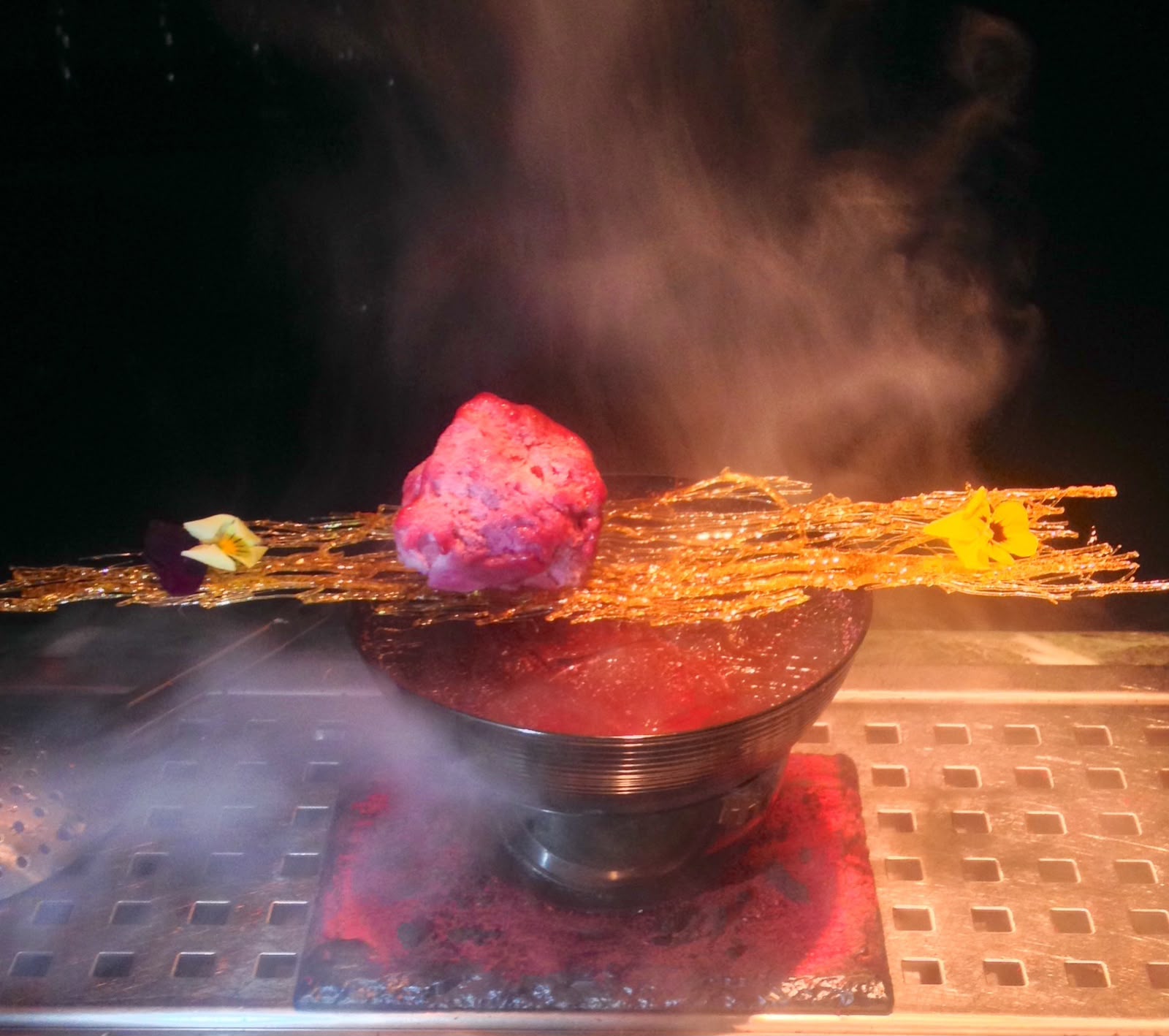 Signature serve with caramel glass, pansies and a smoking rock