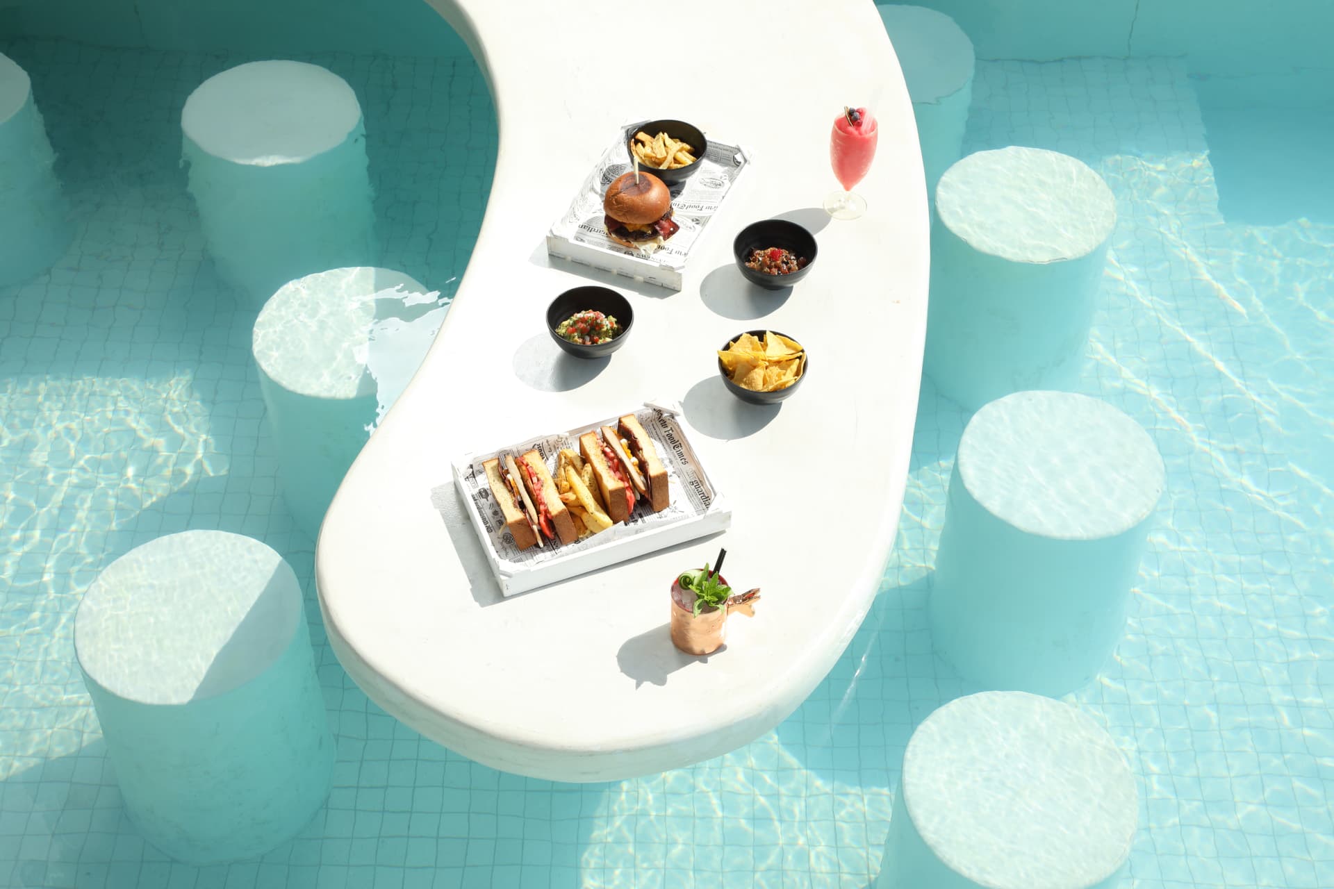 Aerial view of the Esperisma poolside table service in turquoise water