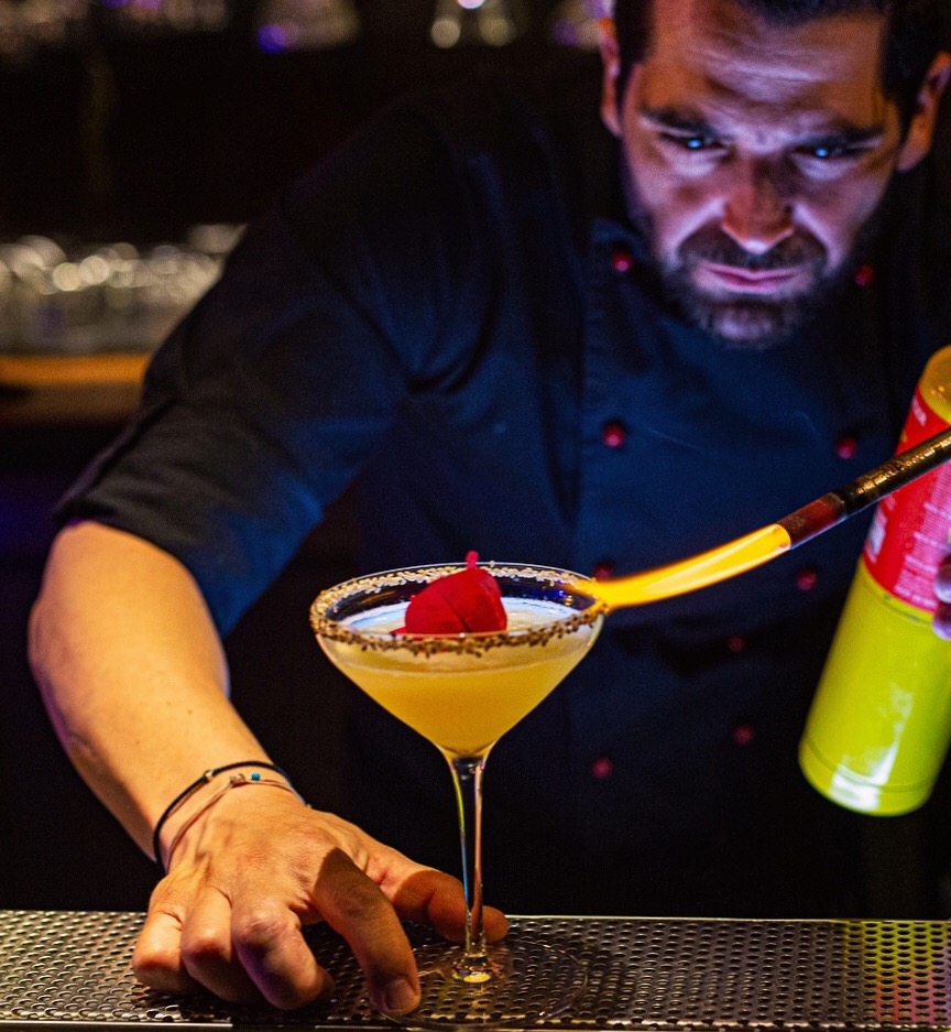Panagiotis Papavramopoulos finishing a cocktail behind the bar