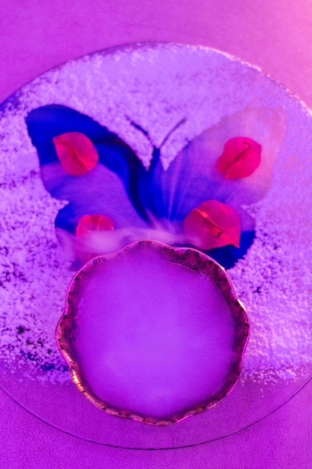 Overhead serve with a pressed butterfly and bougainvillea petals