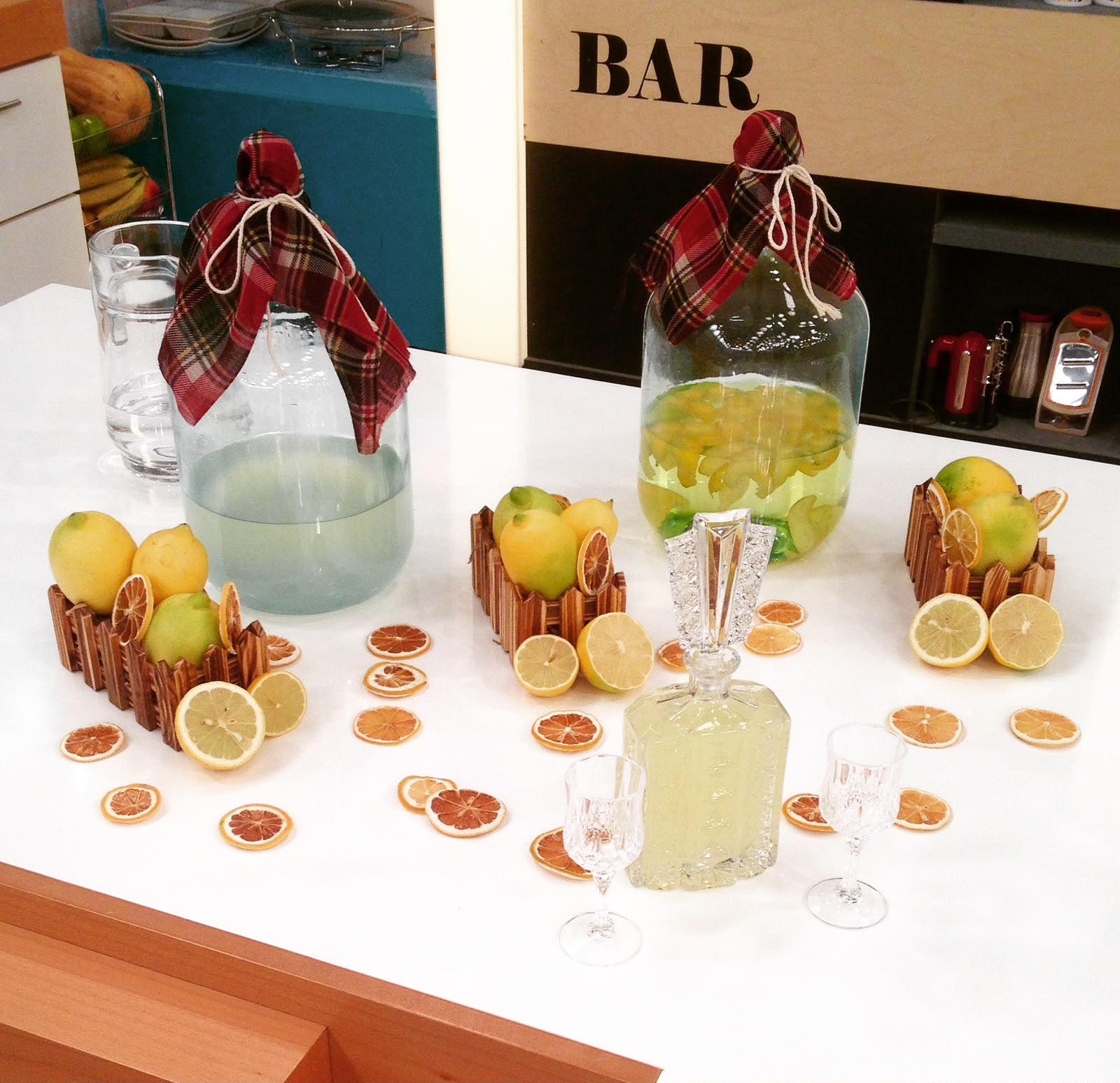 Studio bar set with demijohns of homemade citrus liqueur and dried fruit