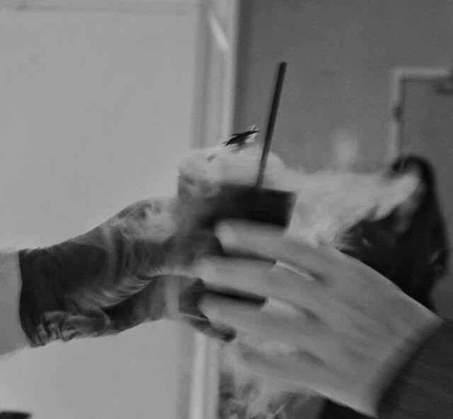 Guest receiving a smoking cocktail, hand to hand