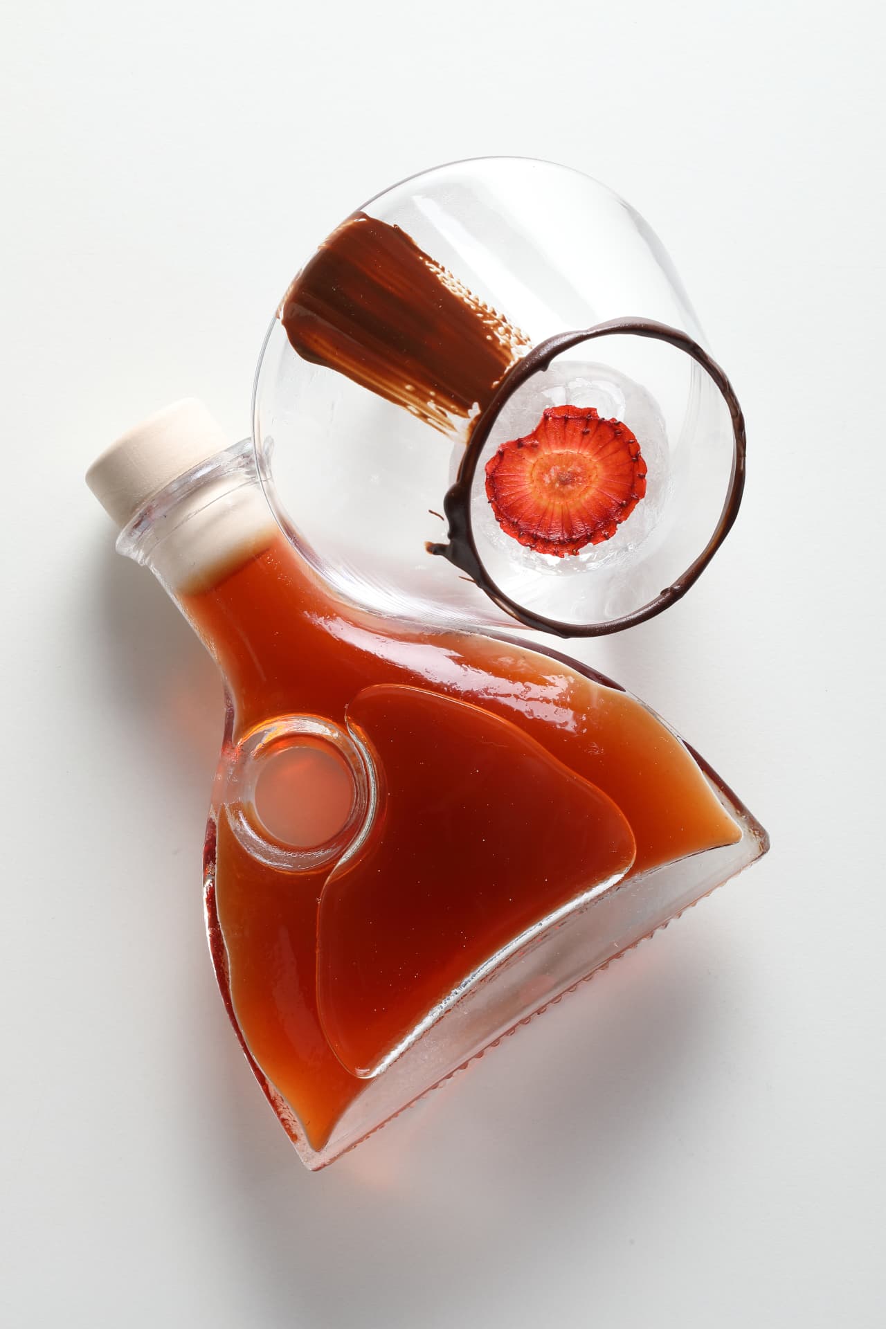 Bottled cocktail with a chocolate-lined glass and strawberry ice, seen from above