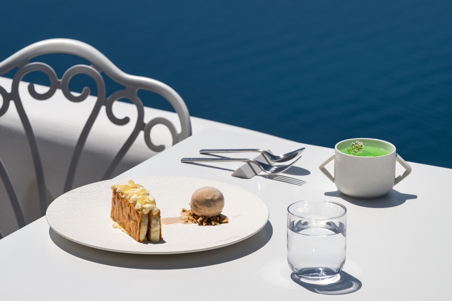 Millefeuille dessert with ice cream and a green digestif by the caldera